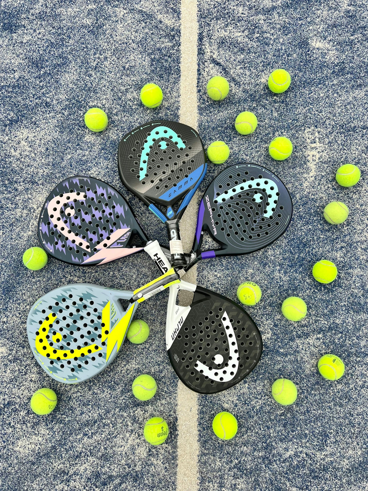 a pair of tennis rackets and balls on the ground