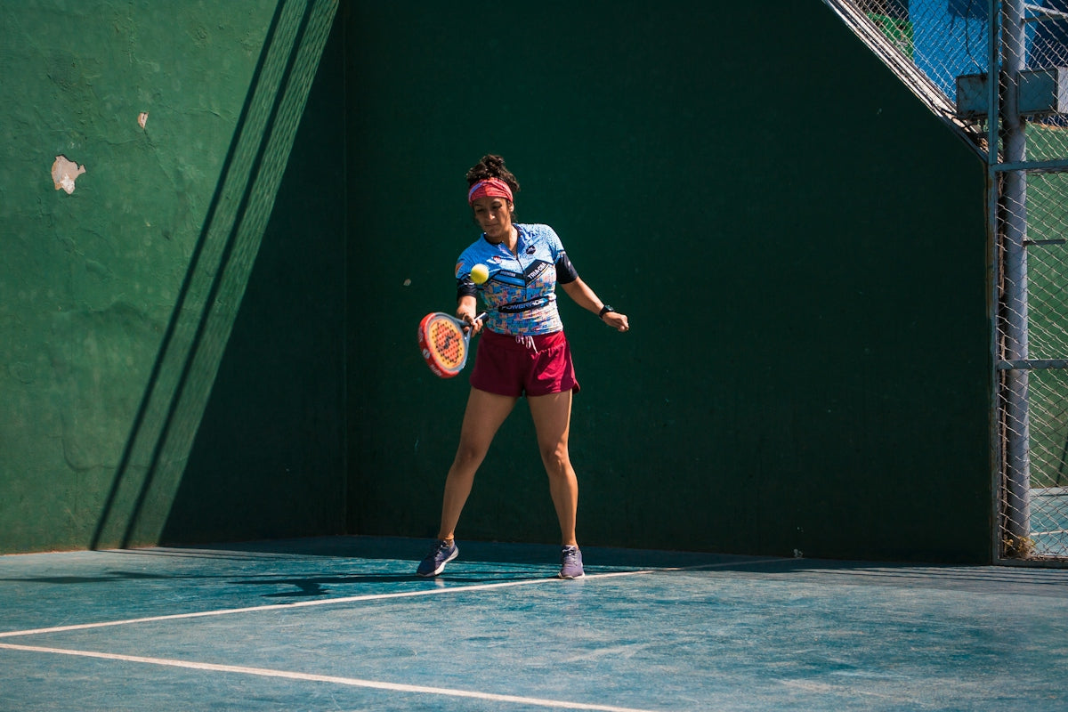 a female tennis player in action on the court