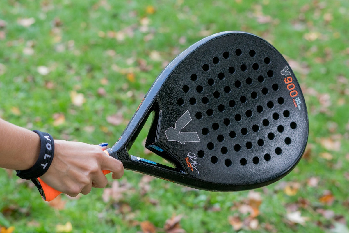 A close up of a person holding a tennis racket